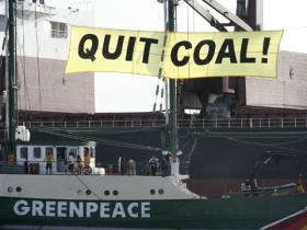 Greenpeace flagship, Rainbow Warrior, anchors alongside MV Medi Firenze which unloads cargo at the Pagbilao coal power plant in Quezon province, around 300 kms south of Manila 23 May 2008.