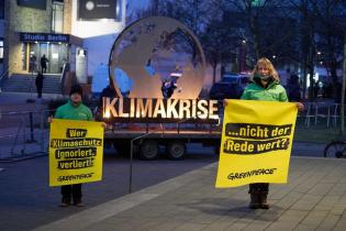 Protest with burning earth symbol at TV duel of chancellor candidates in Berlin