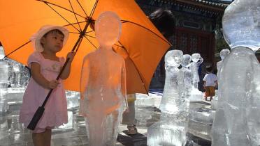 Greenpeace stellt 100 Kinder-Eisskulpturen am Tempel of the Earth in Peking auf, August 2009