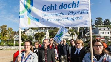 Klimapilger halten Banner mit der Aufschrift "Geht doch" hoch.