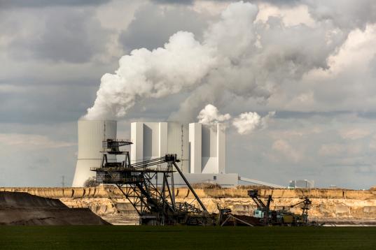 Braunkohlekraftwerk Lippendorf: Kühltürme und Schornsteine mit Rauch, davor Bagger im Braunkohletagebau