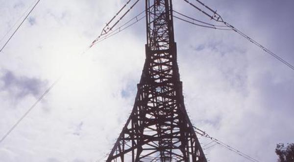 Hochspannungsleitung und Strommast vor dem Atomkraftwerk ( AKW ) Isar 1 der Bayernwerke.